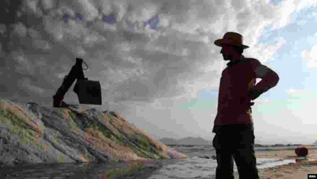 Iran – A digger during salt extraction on Lake Urmia, Tabriz, Sep2012 