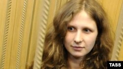 Russia -- Maria Alekhina, a member of female Russian punk band Pussy Riot, stands inside defendants cage in a Moscow court, 19Apr2012